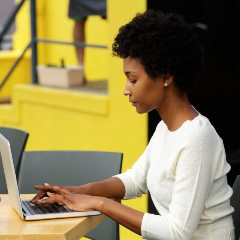 attractive-young-woman-using-laptop-outside-P9RLFGU@2x-830x6472